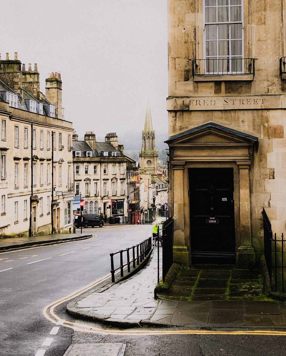 street lined with stone buildings with gray skies
