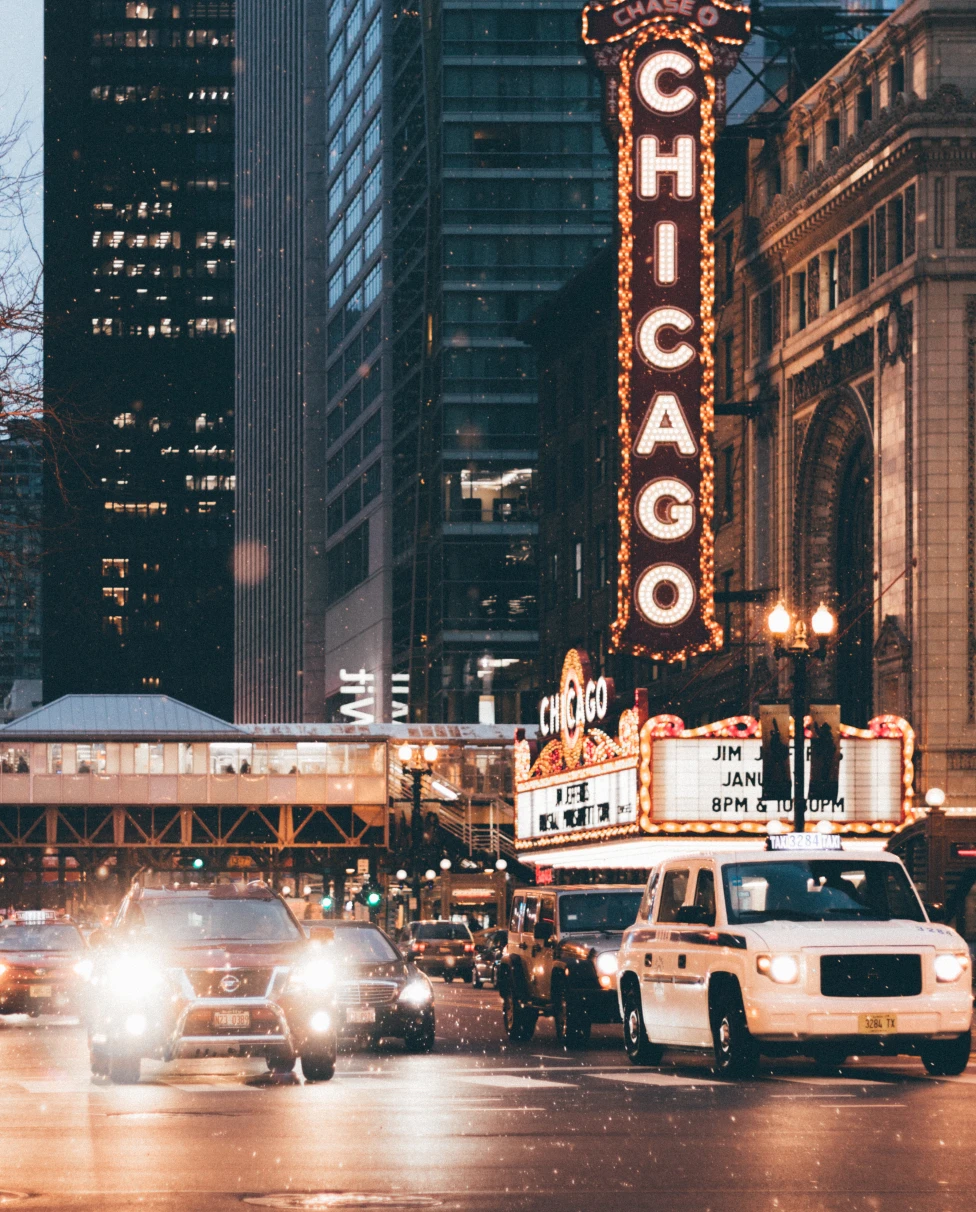 building with large chicago sign next to busy street
