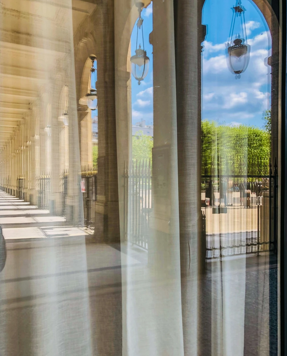 Inside a hotel building looking outside during the day.