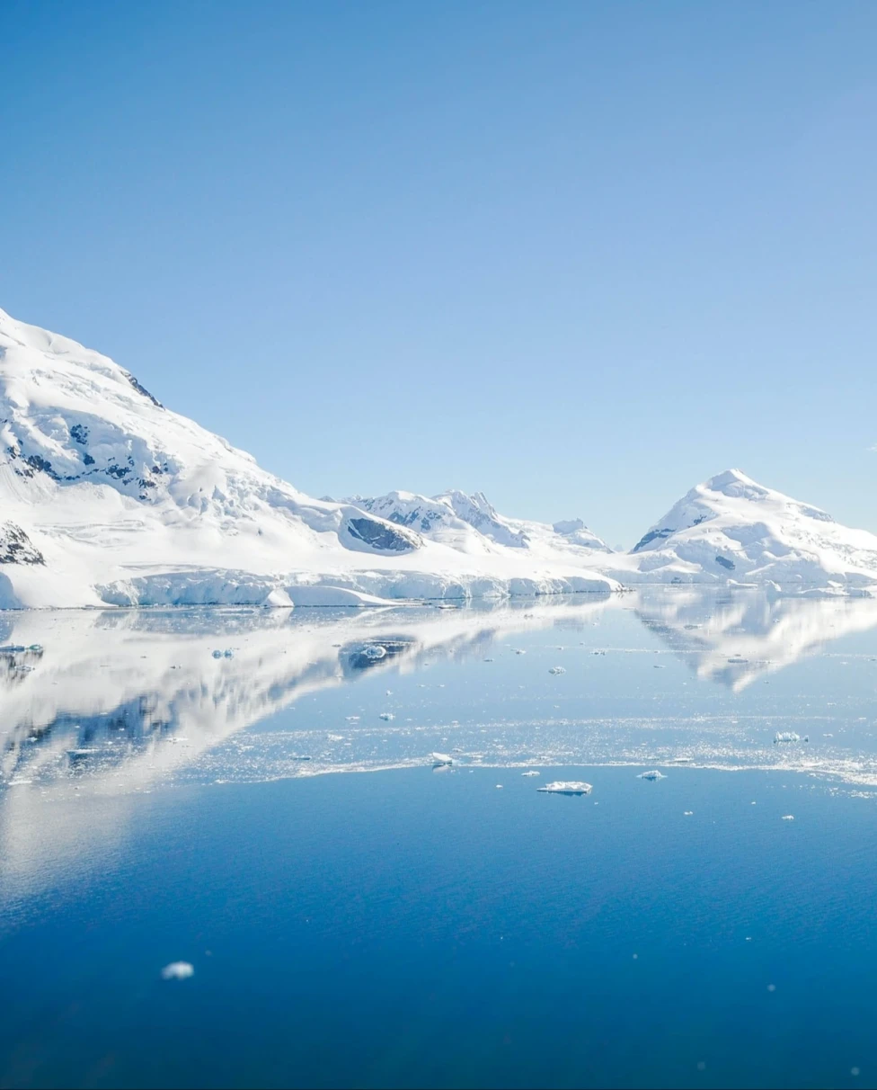 Mountain with snow near body of water is the beauty of Antarctica.