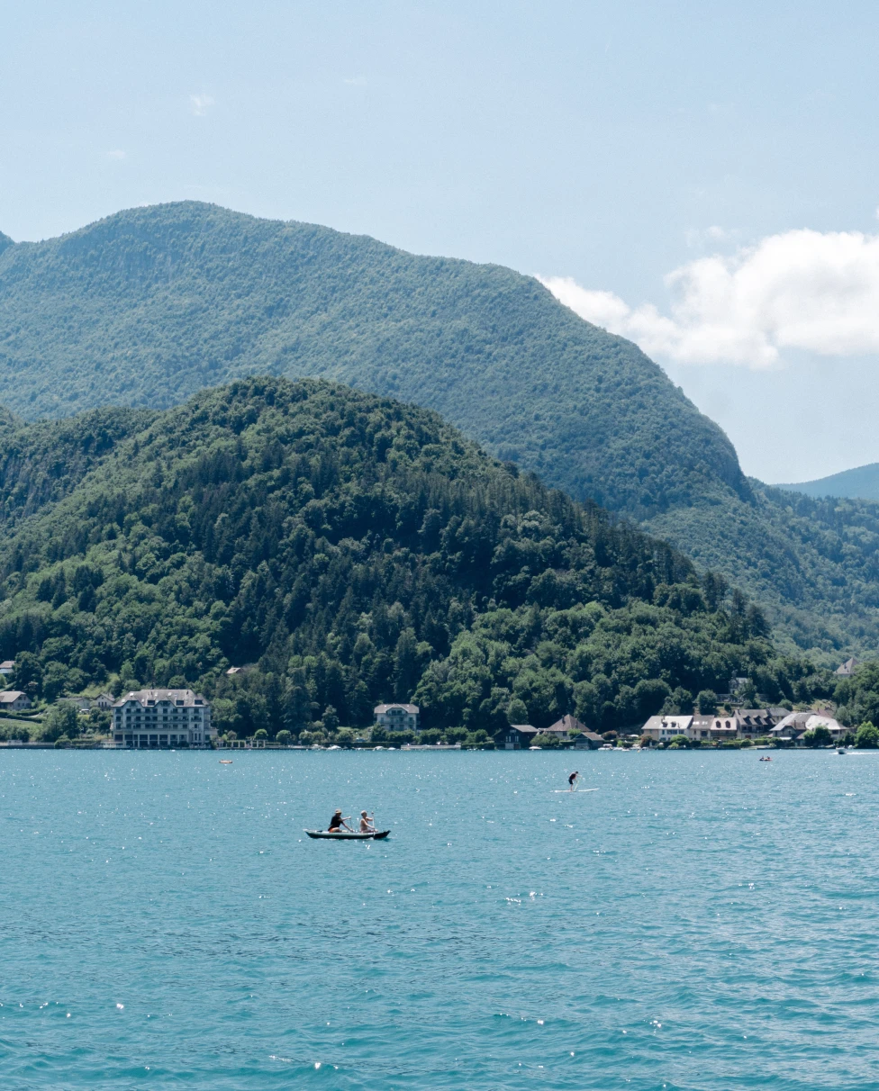 blue lake next to mountains during daytime