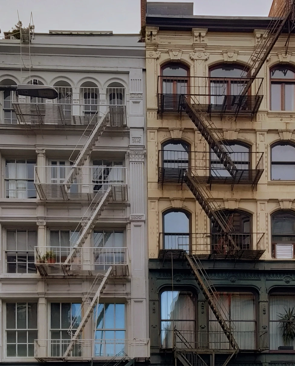 Two, white and black, buildings in New York City.