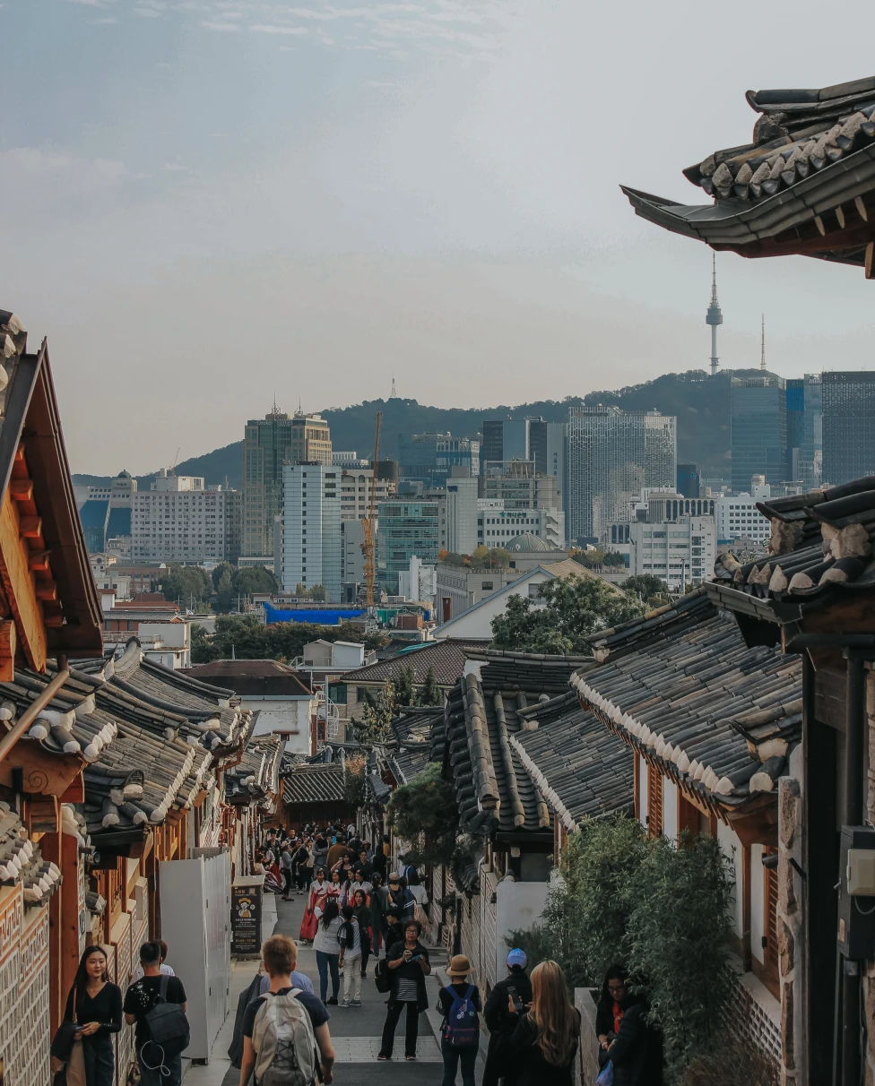 people walking down stairs with buildings in background