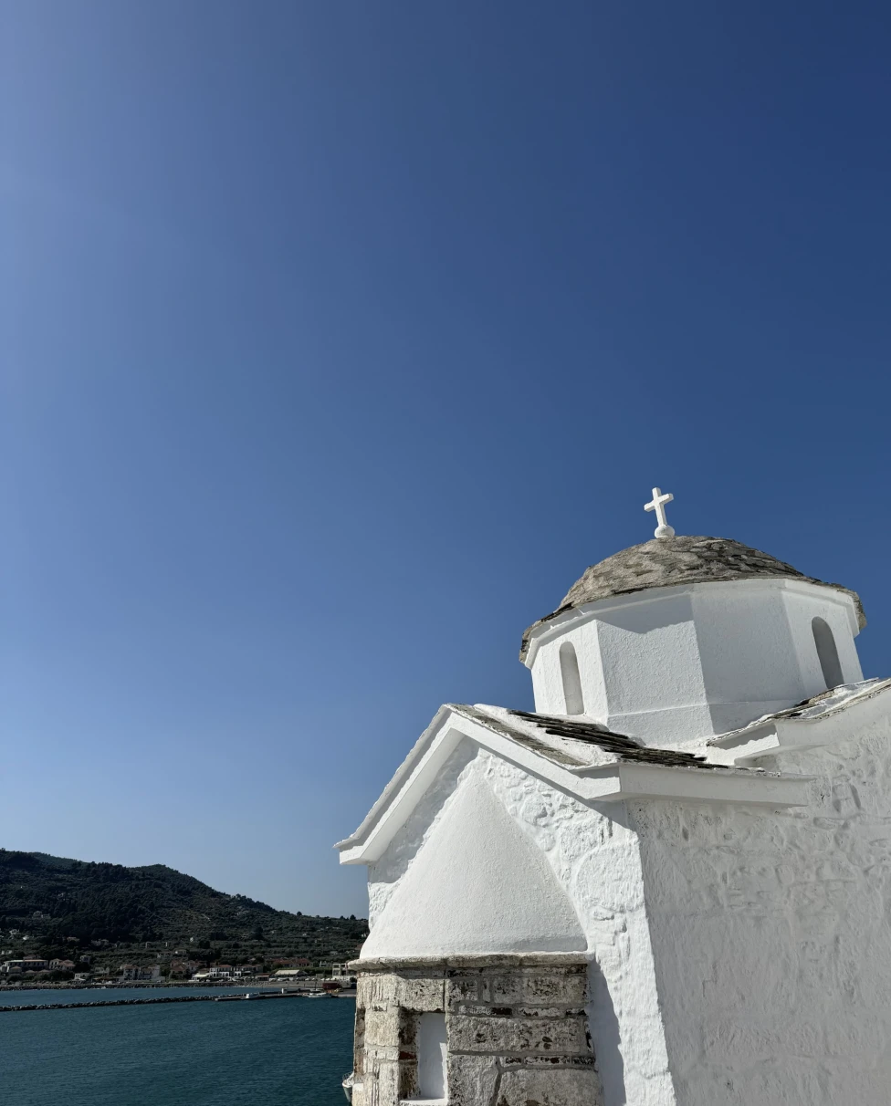 White church building with the ocean in the background