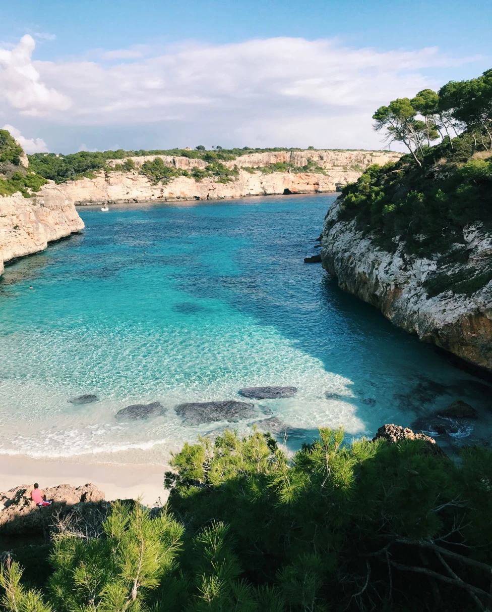 A beach with light blue water during daytime.