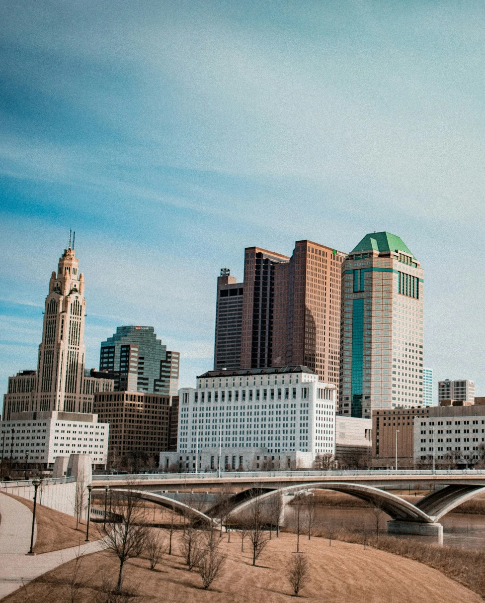 Tall city buildings with cloudy skies during daytime