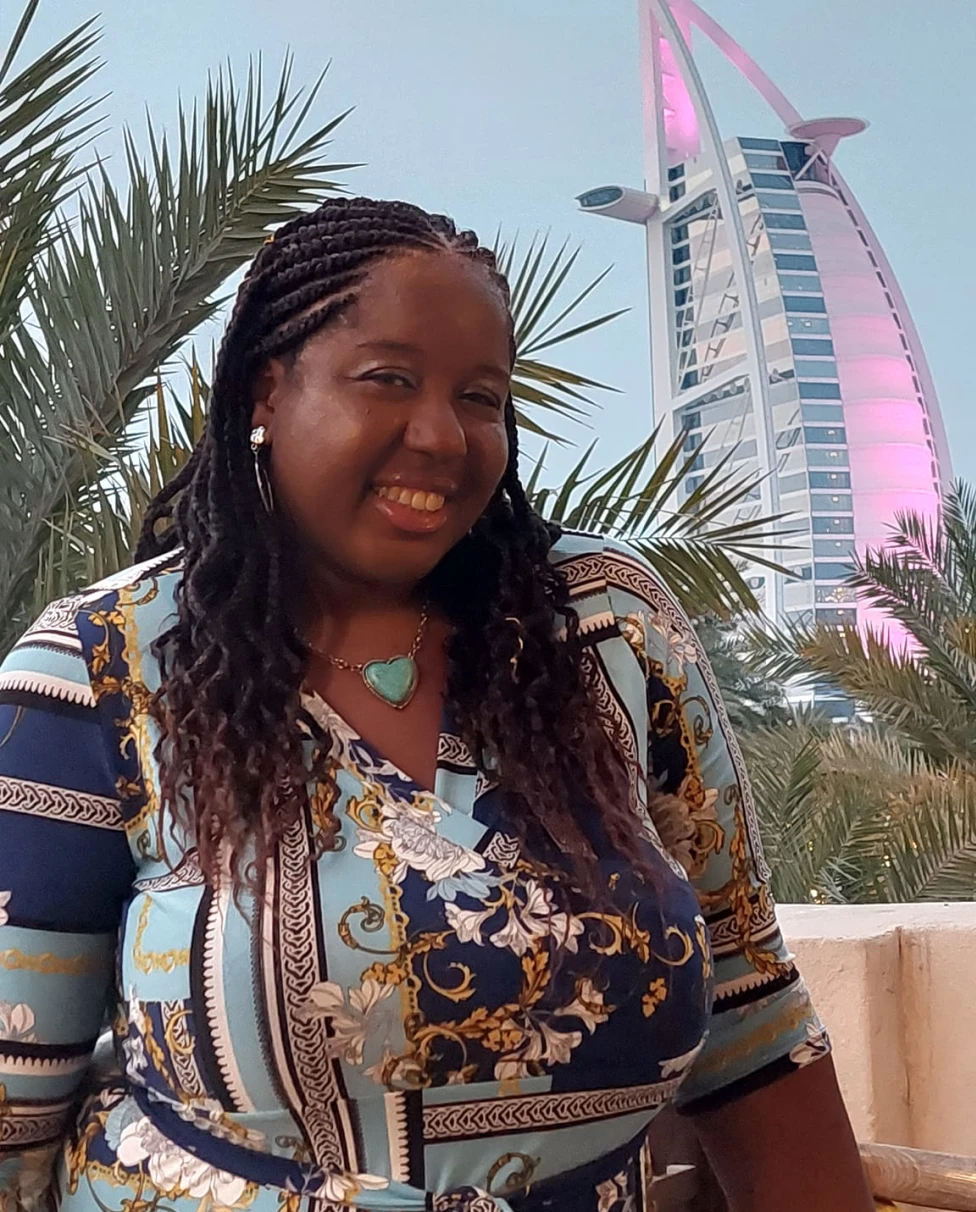 Guide posing for a photo with a tower in the background