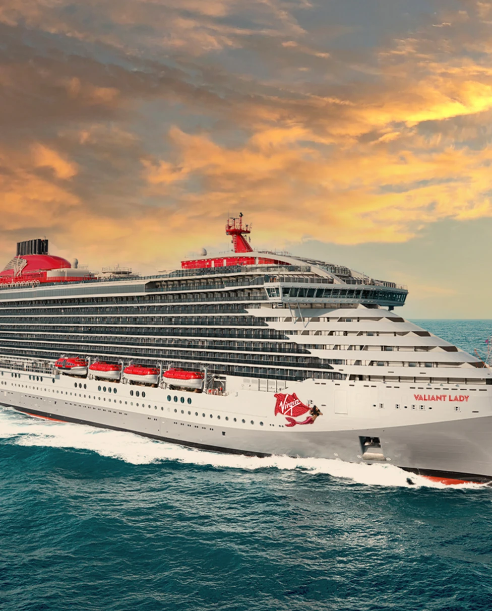 cruise ship in water during sunset