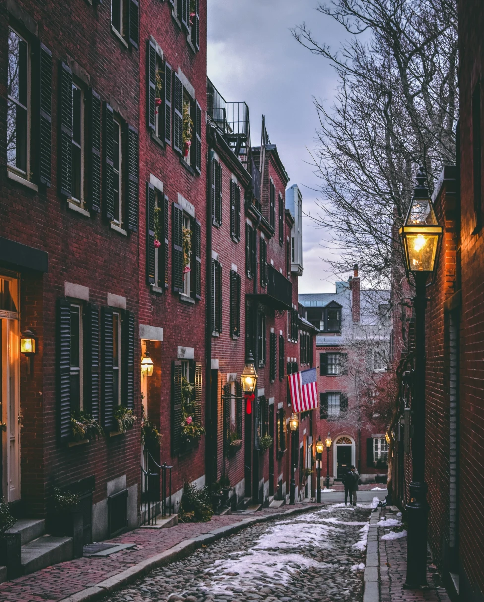 A narrow street with red brick homes on each side