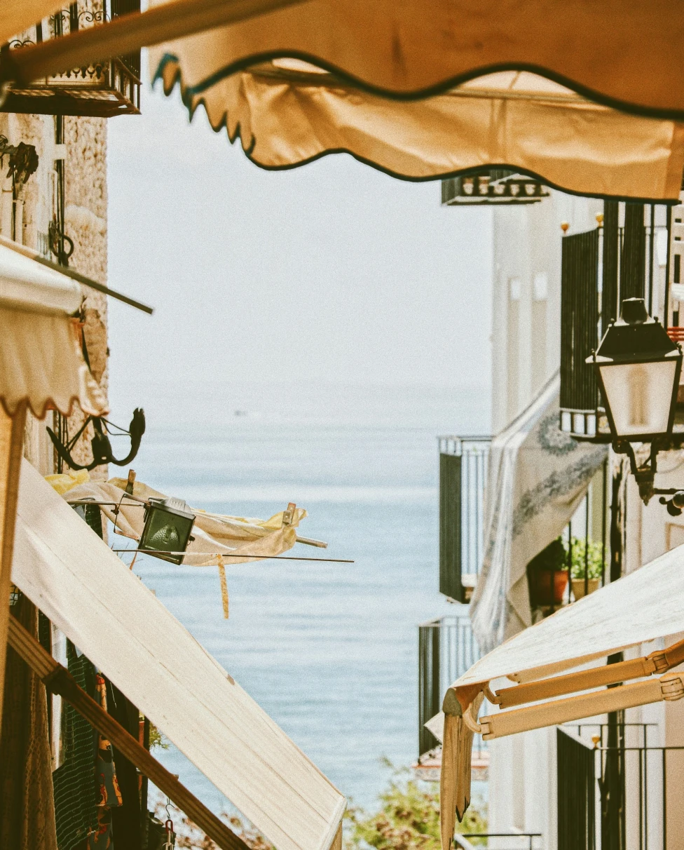 Buildings with ocean at back.