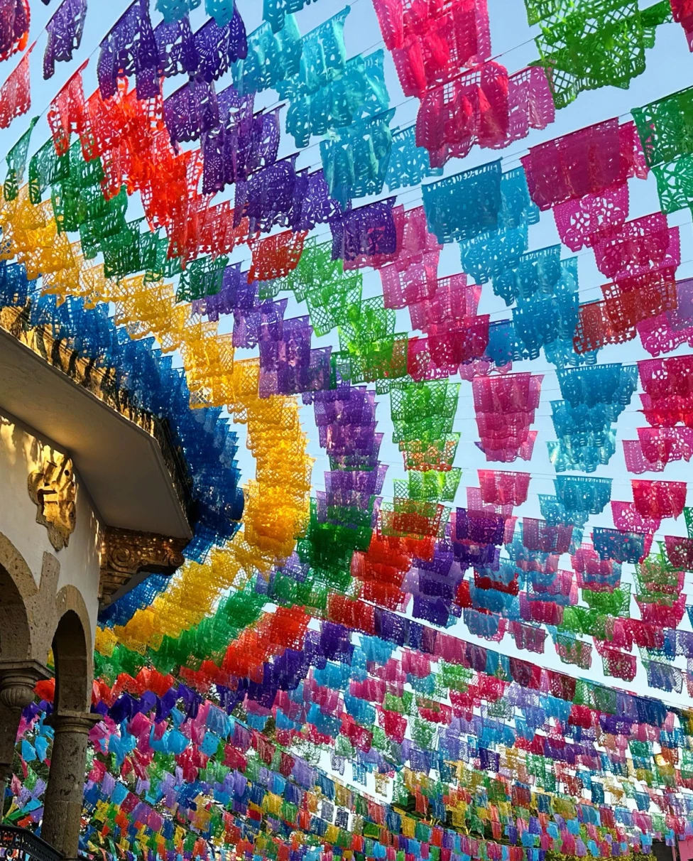 color flags strung through the air over a busy market