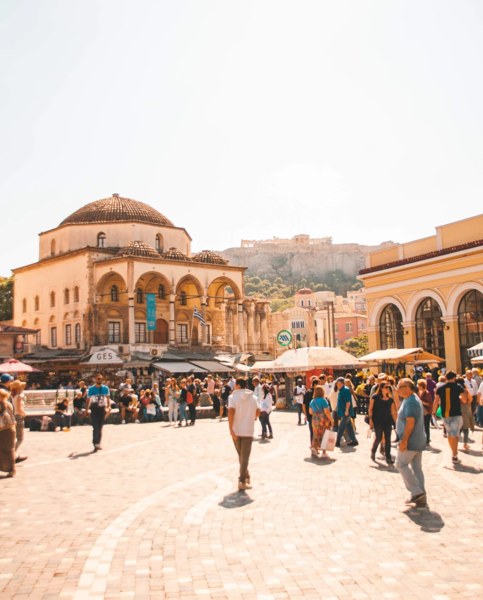 People walking in city square on cloudy day during daytime