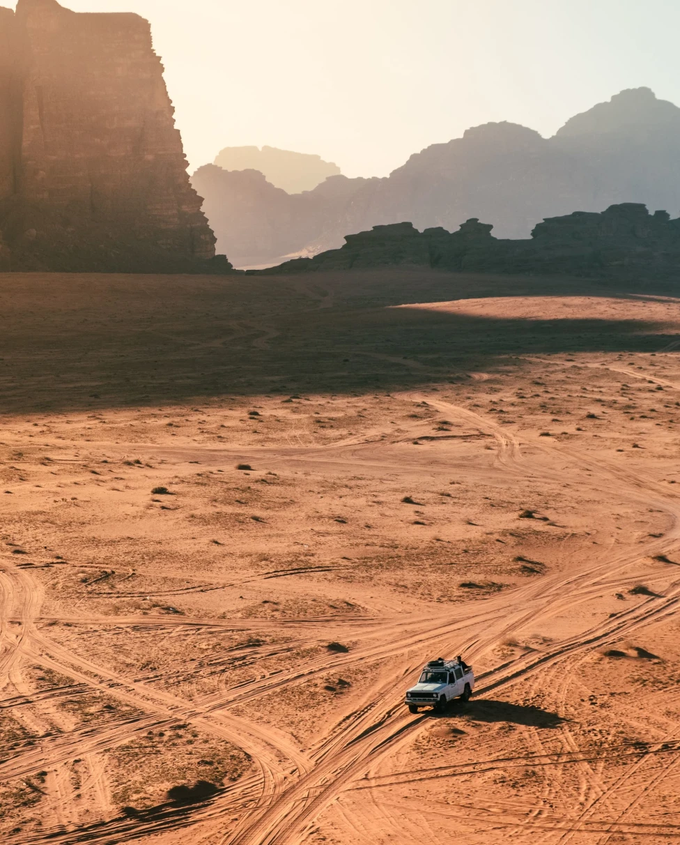 desert vista with jeep driving through it