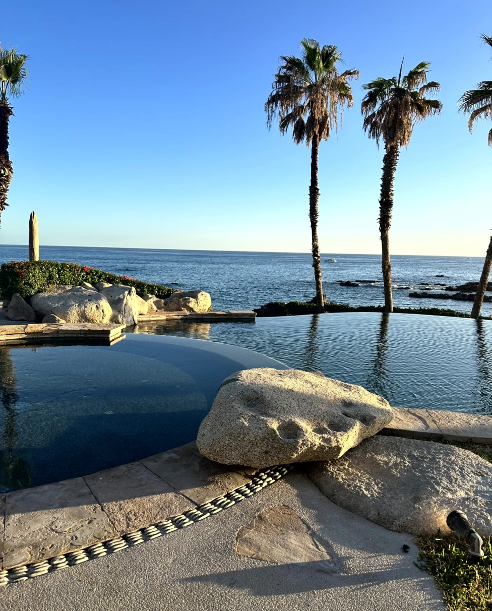 two pools in front of the ocean during daytime