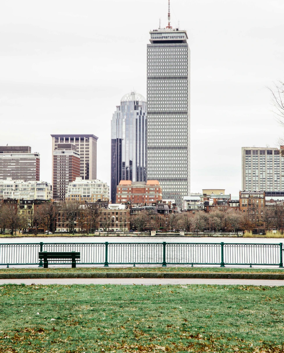 fence and running trail along the water in a modern city