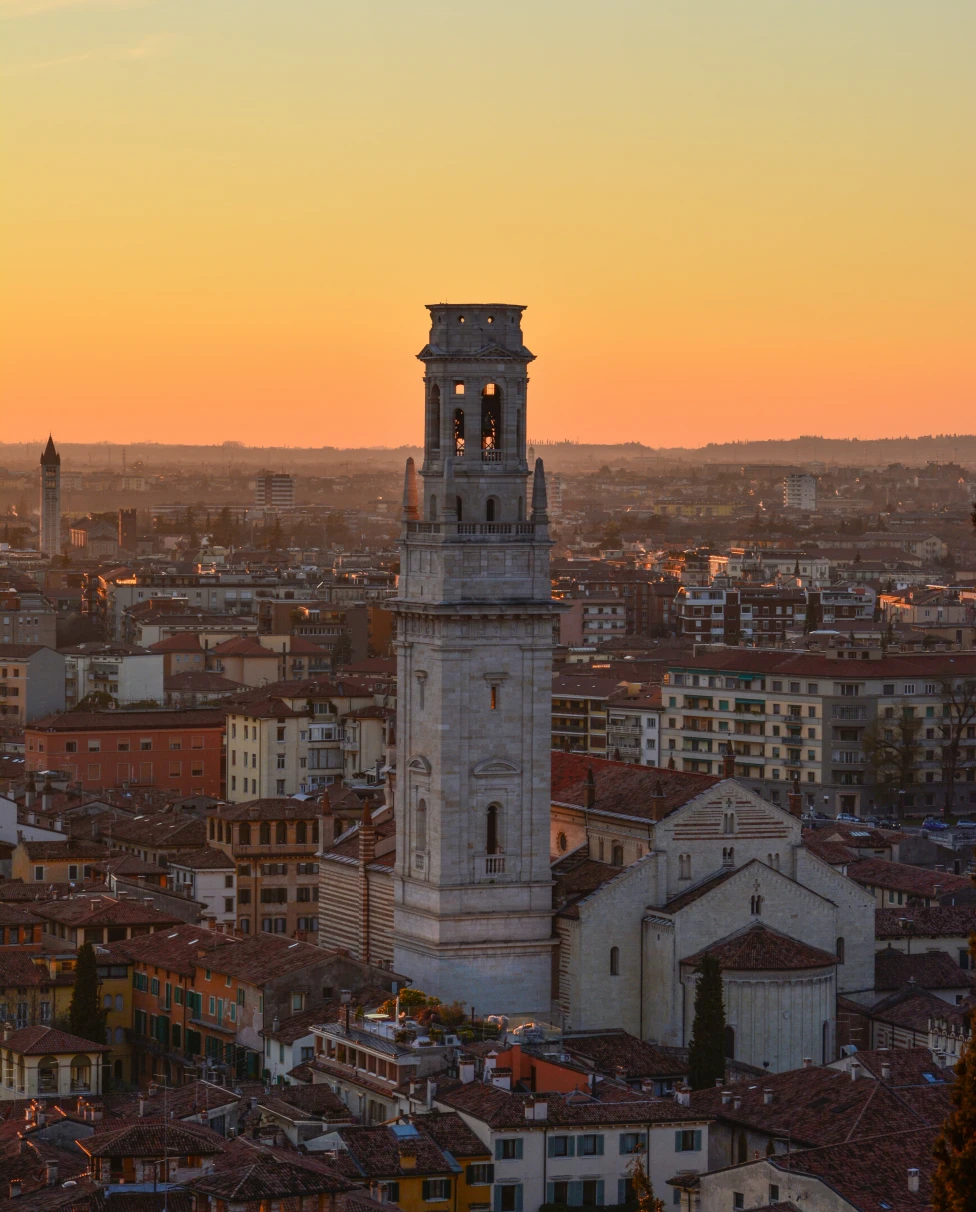 White concrete tower in city during sunset