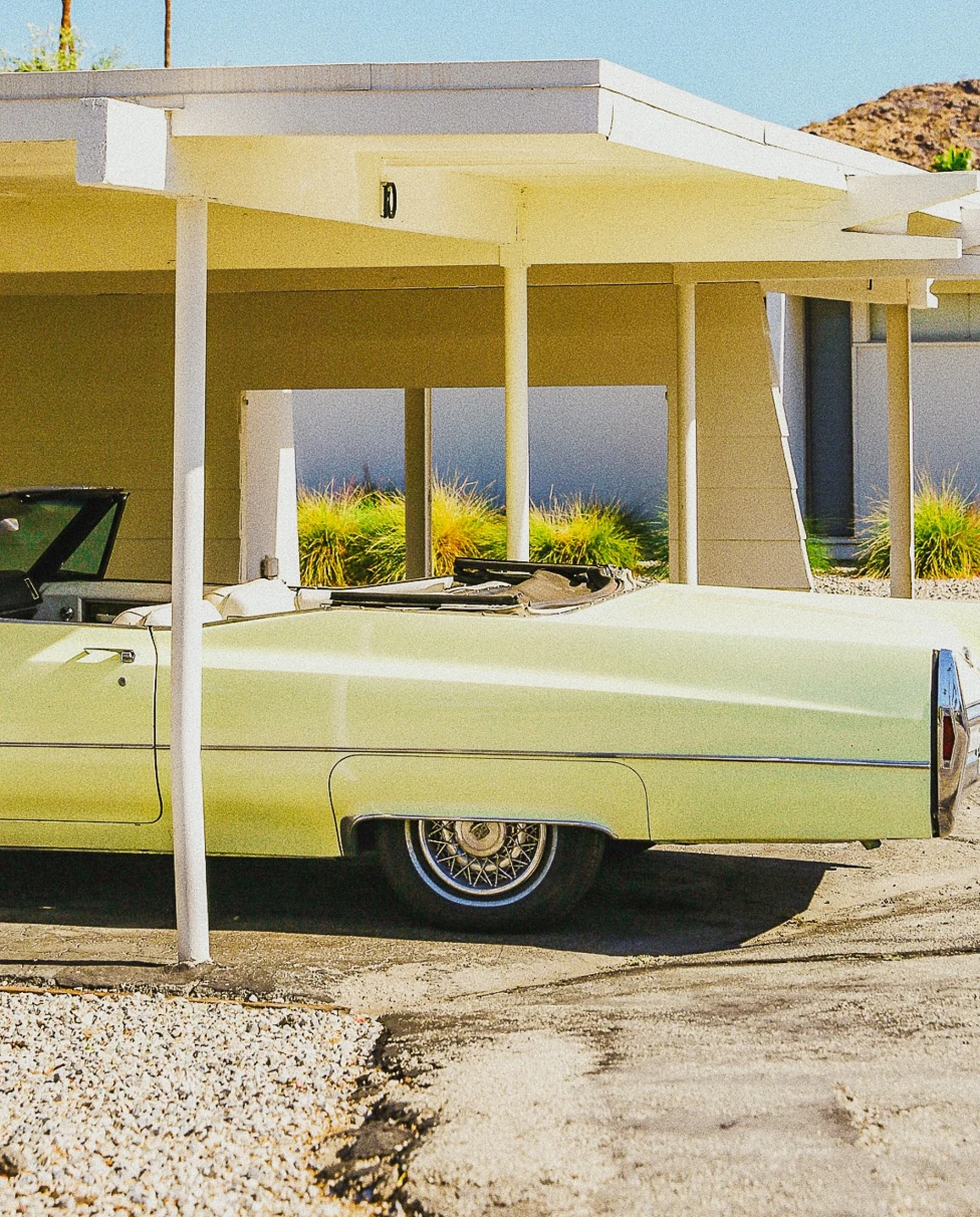Yellow mid-century house and lime green vintage car in Palm Springs.