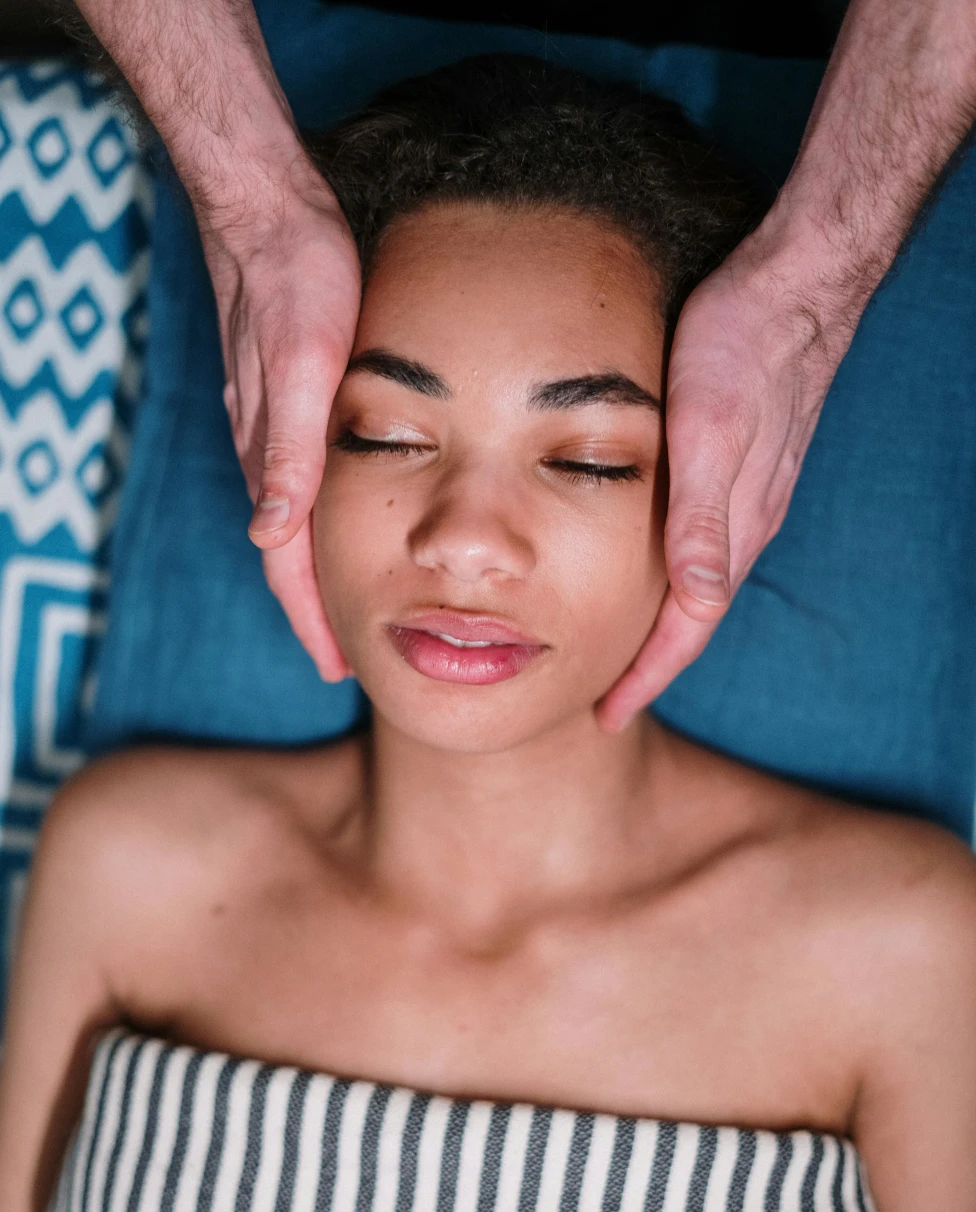 A woman getting a massage with her eyes closed.