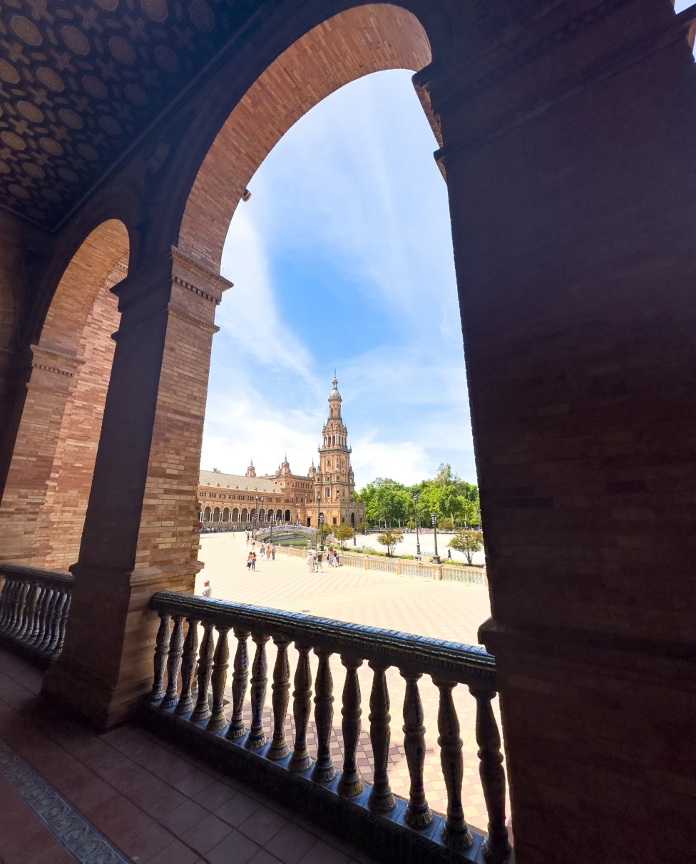 View from terrace overlooking a courtyard under a clear blue sky.