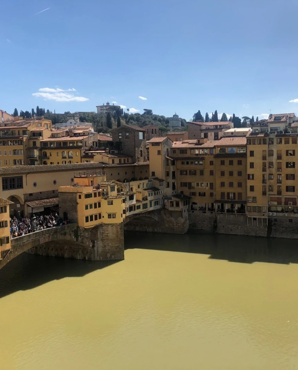Yellow and brown buildings with city lake on a sunny day.