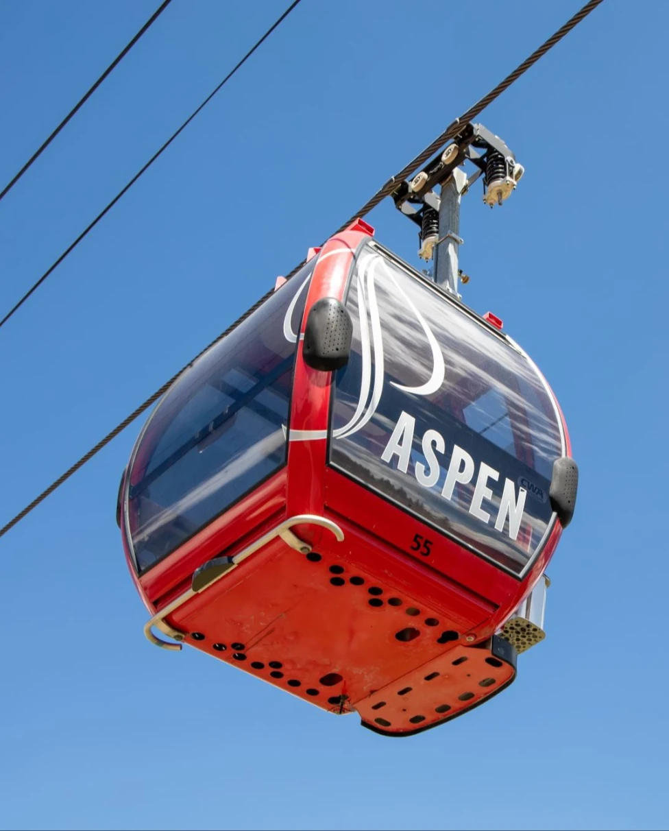 red gondola with the words "Aspen."