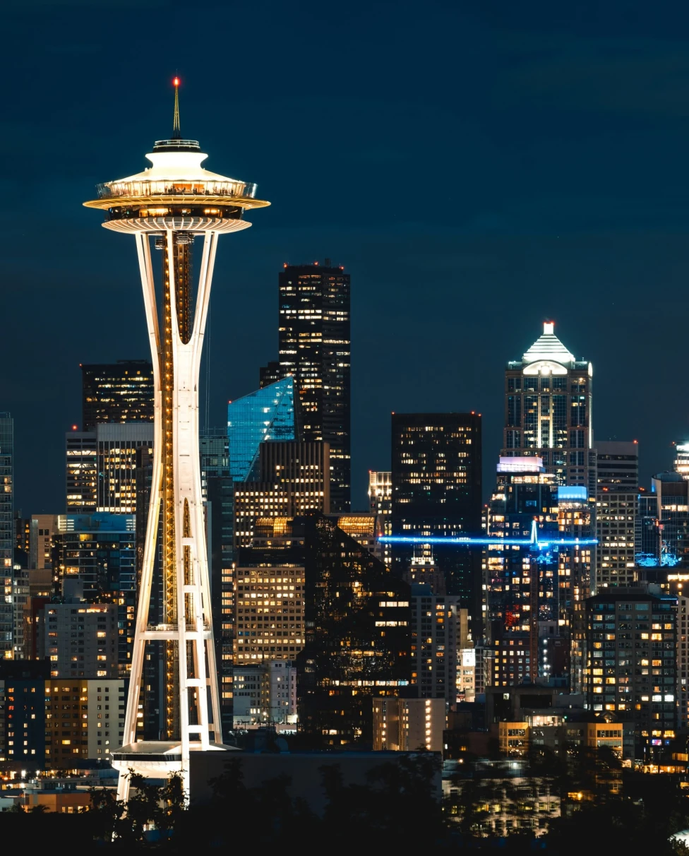 City skyline at night with well lit buildings.