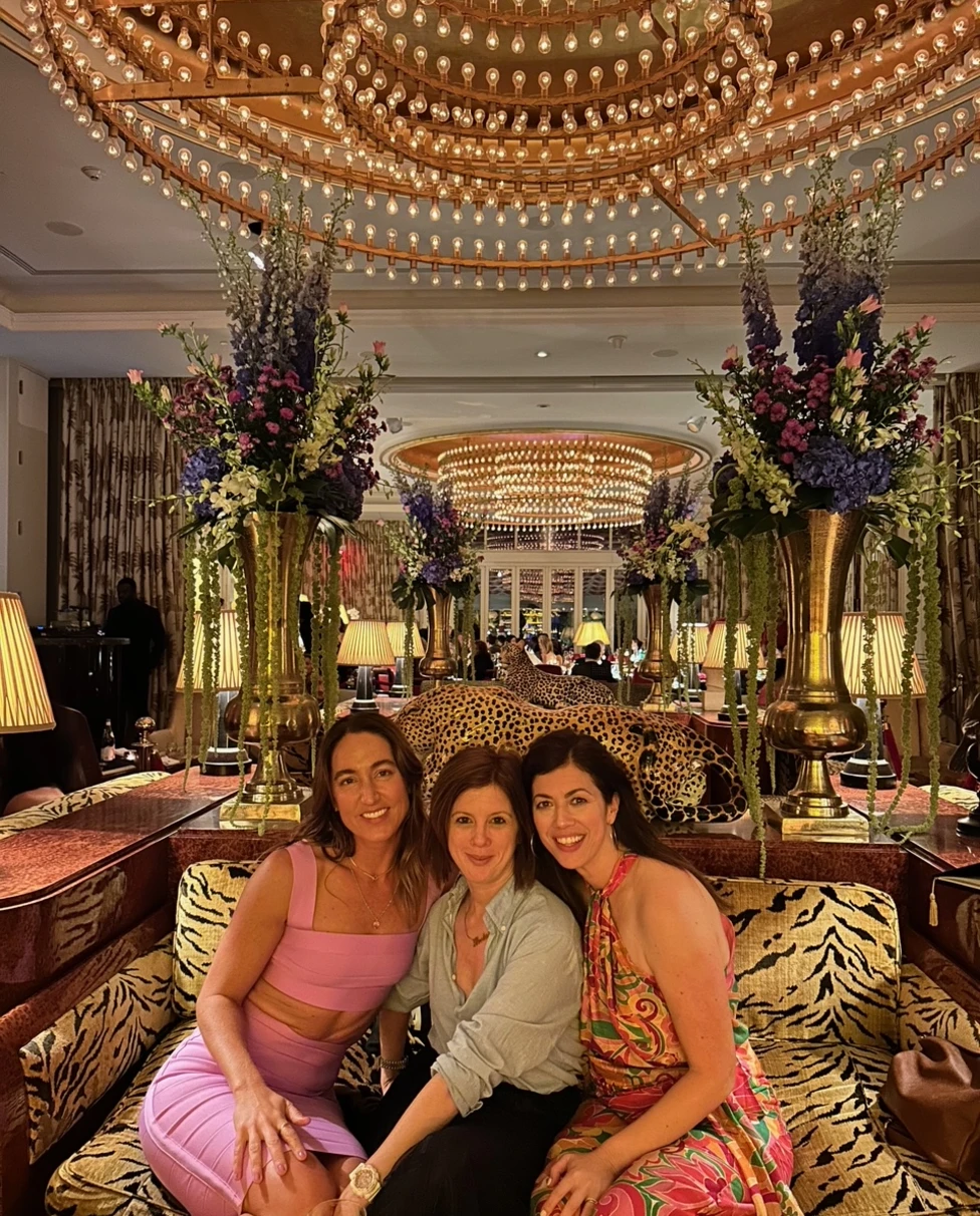 Three women posing on a couch in doors