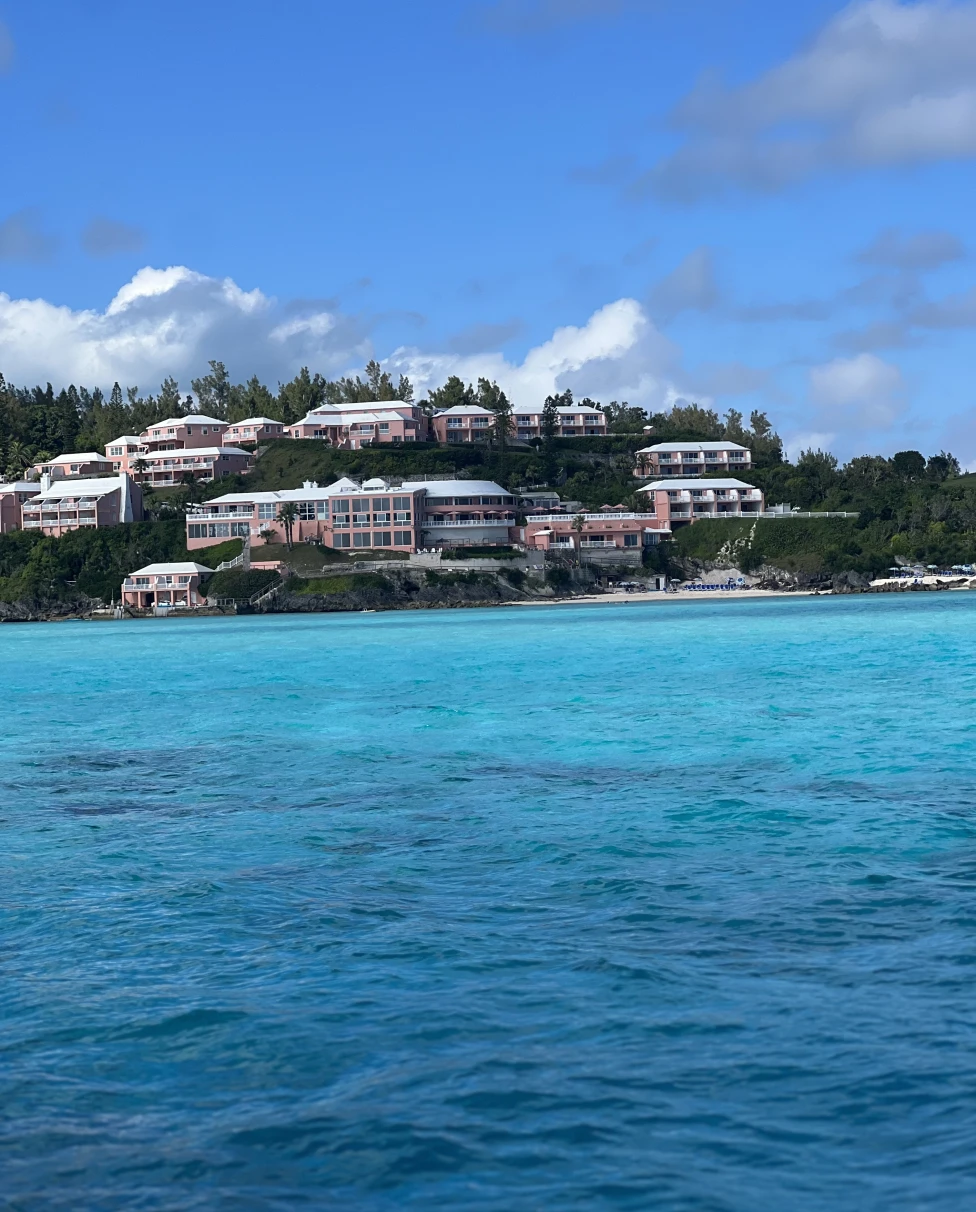 Blue water with multiple houses on the background