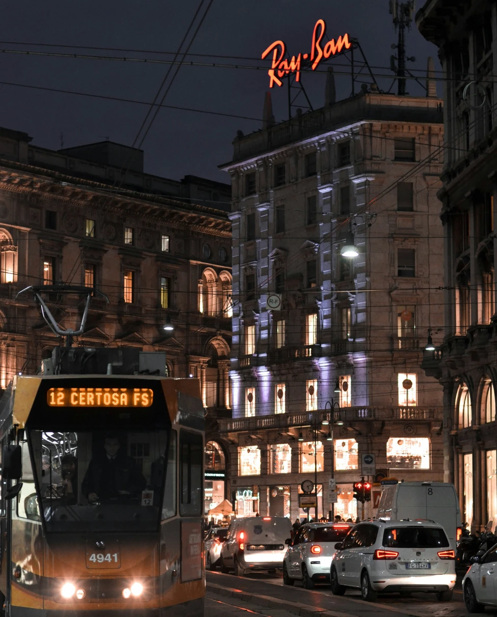 A tram car turning through the nighttime streets of Milan, Italy.