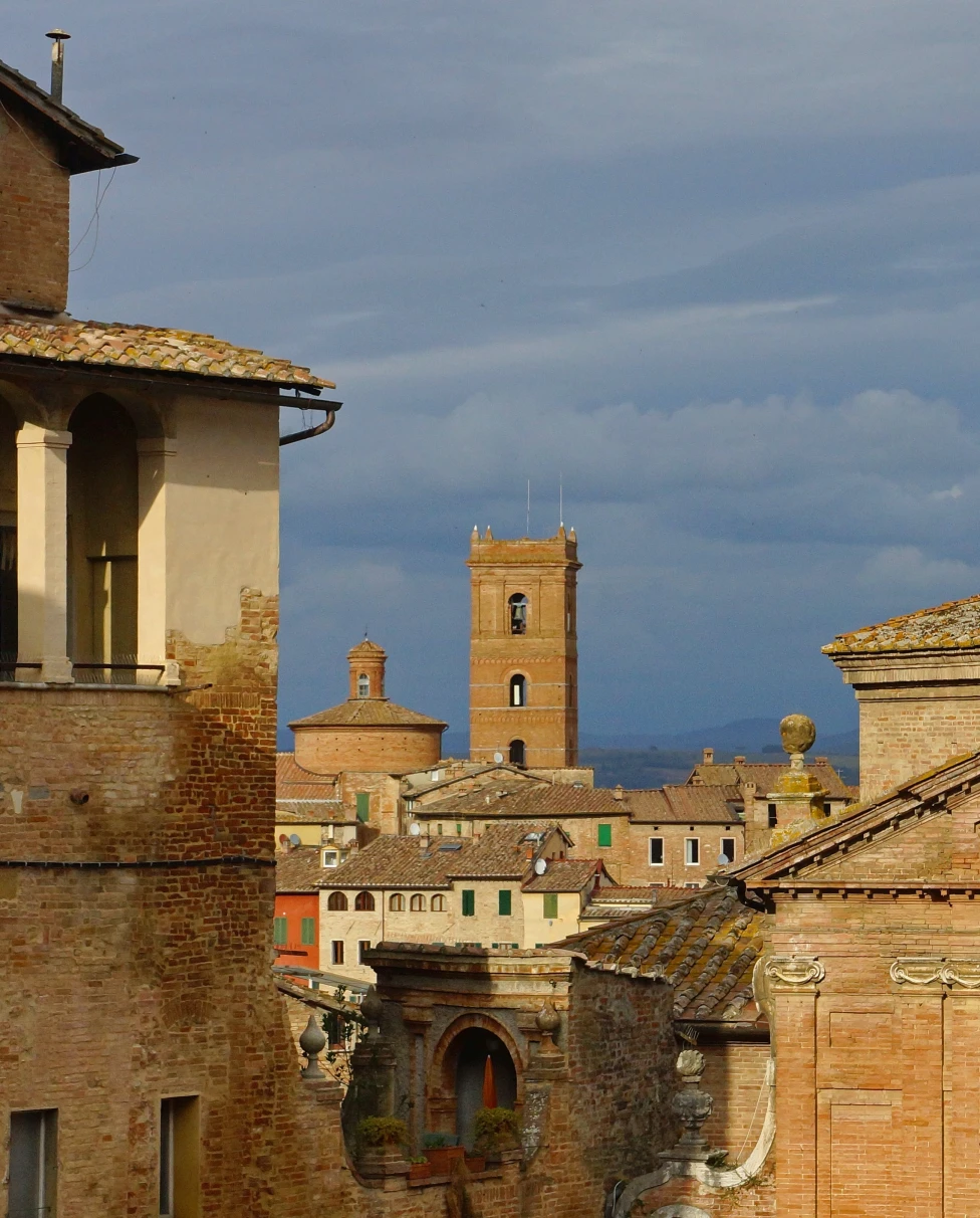 Skyline with tower in old city of Siena, Tuscany in Italy on a cloudy day.
