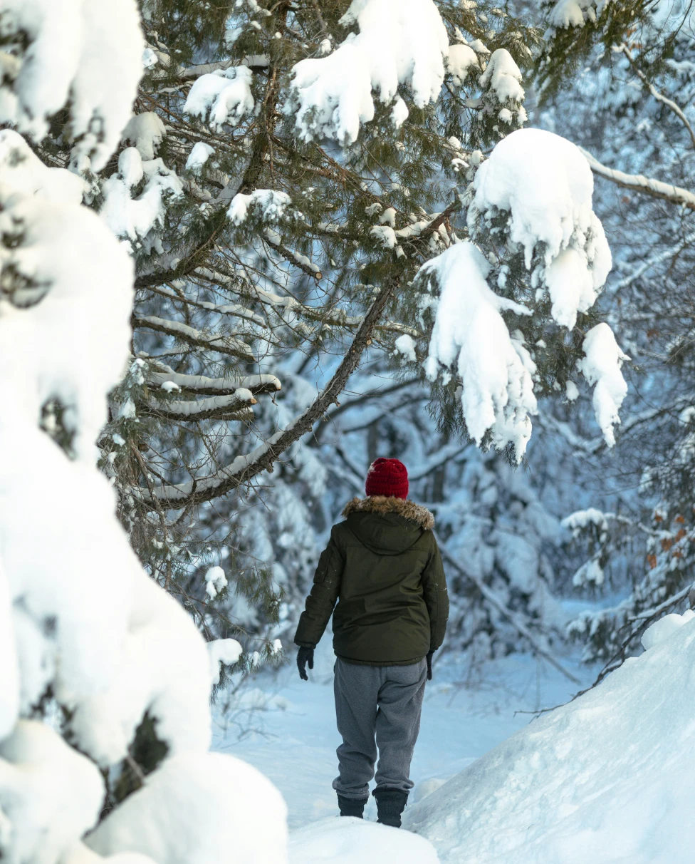 A woman on a snowy mountain looking happy