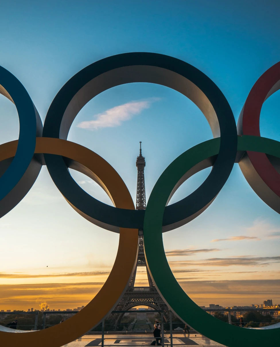 Olympic sign in front of Eiffel Tower.