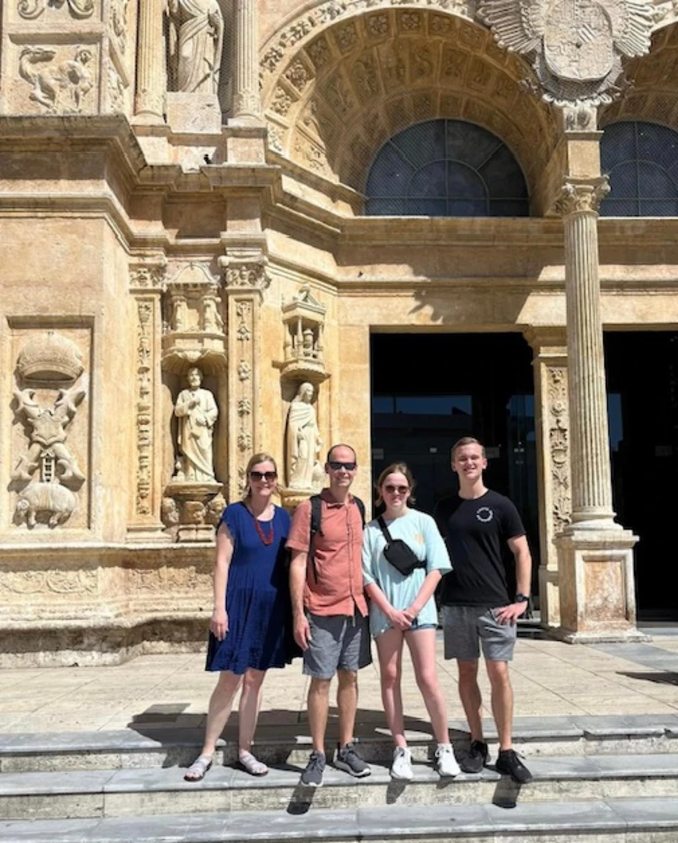 A family outside of an intricately carved church