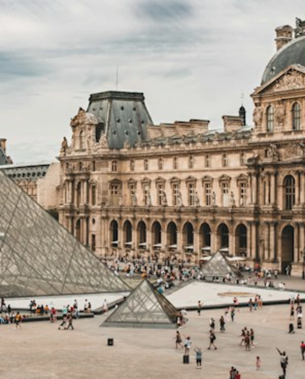 people gathering near Louvre Museum during daytime
