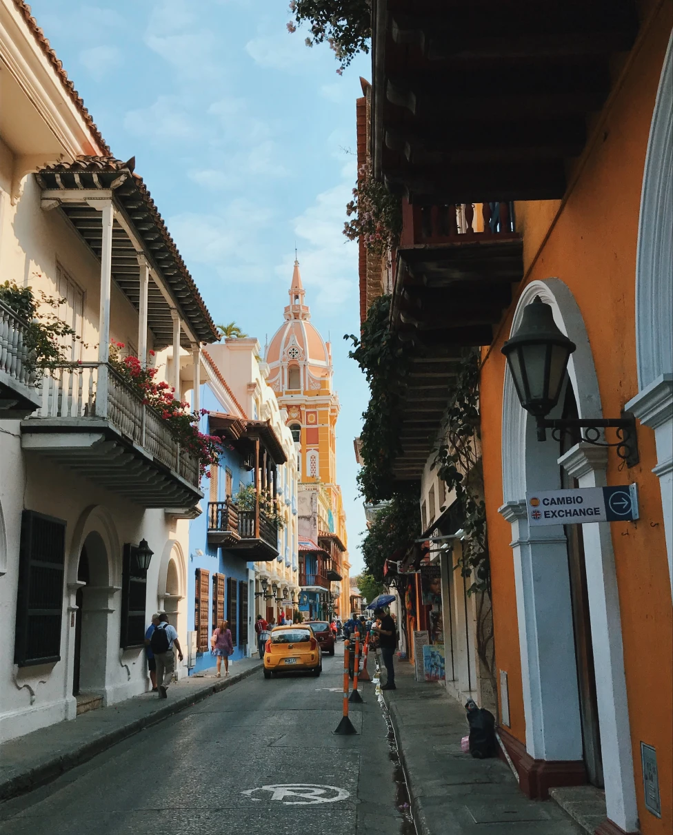 colorful historic narrow street with cars at daytime