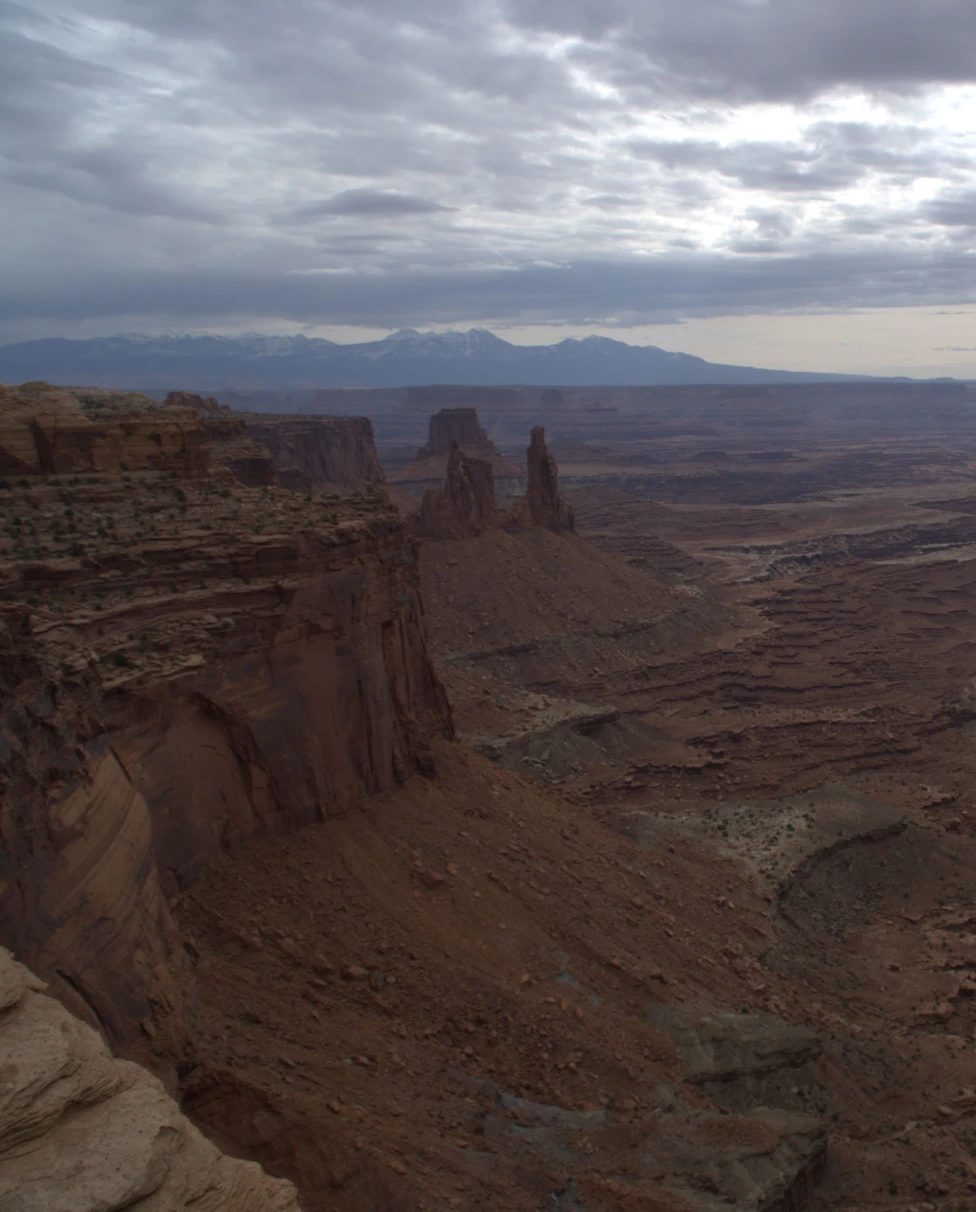 Brown steep area surrounded by rocky hills.