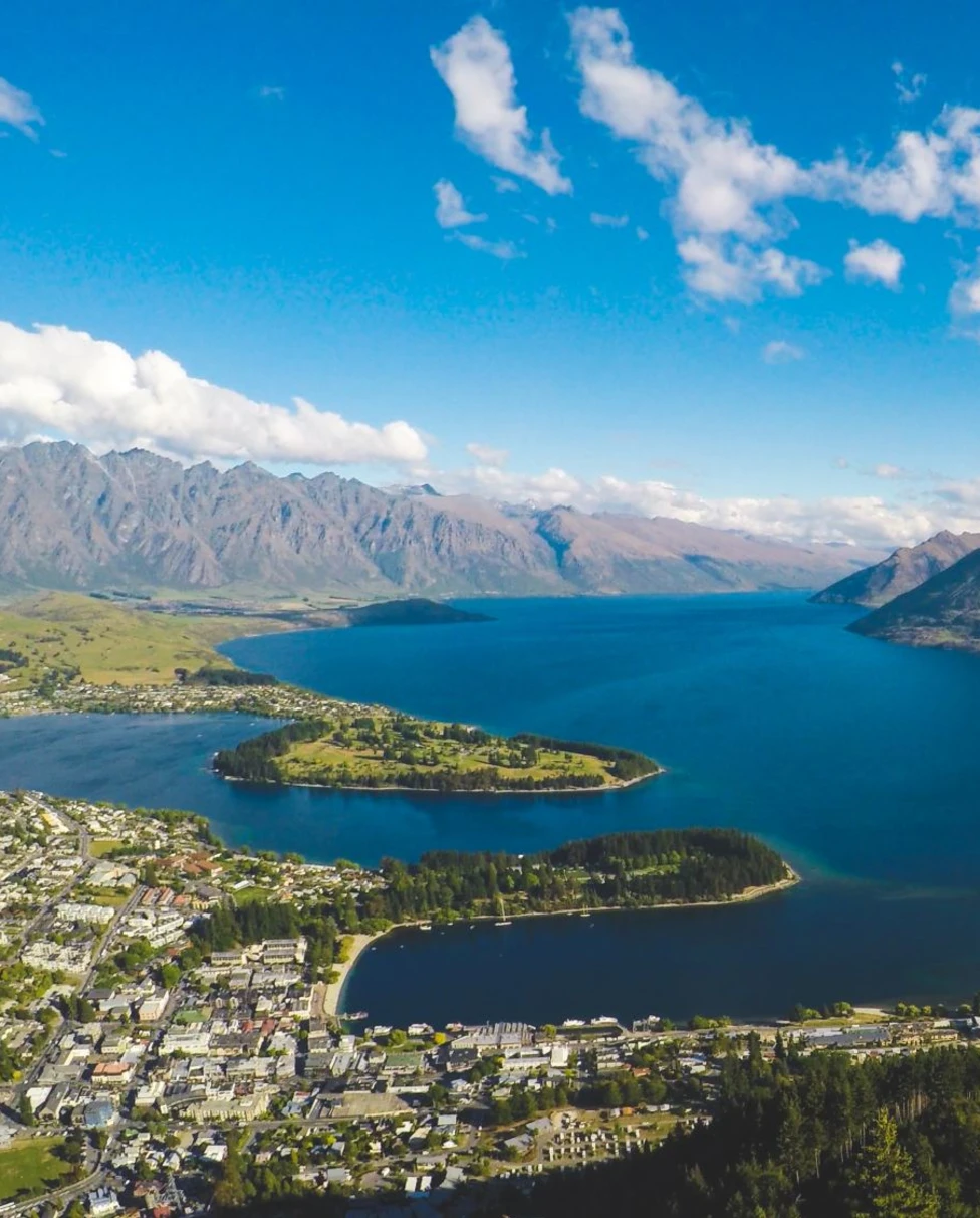 city on a river and mountains
