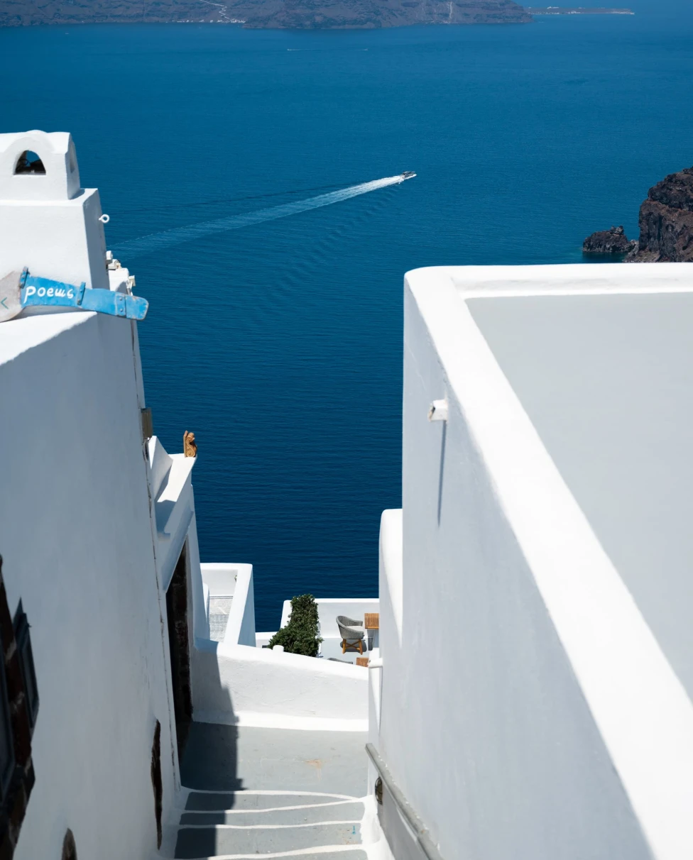 royal blue water below a white city