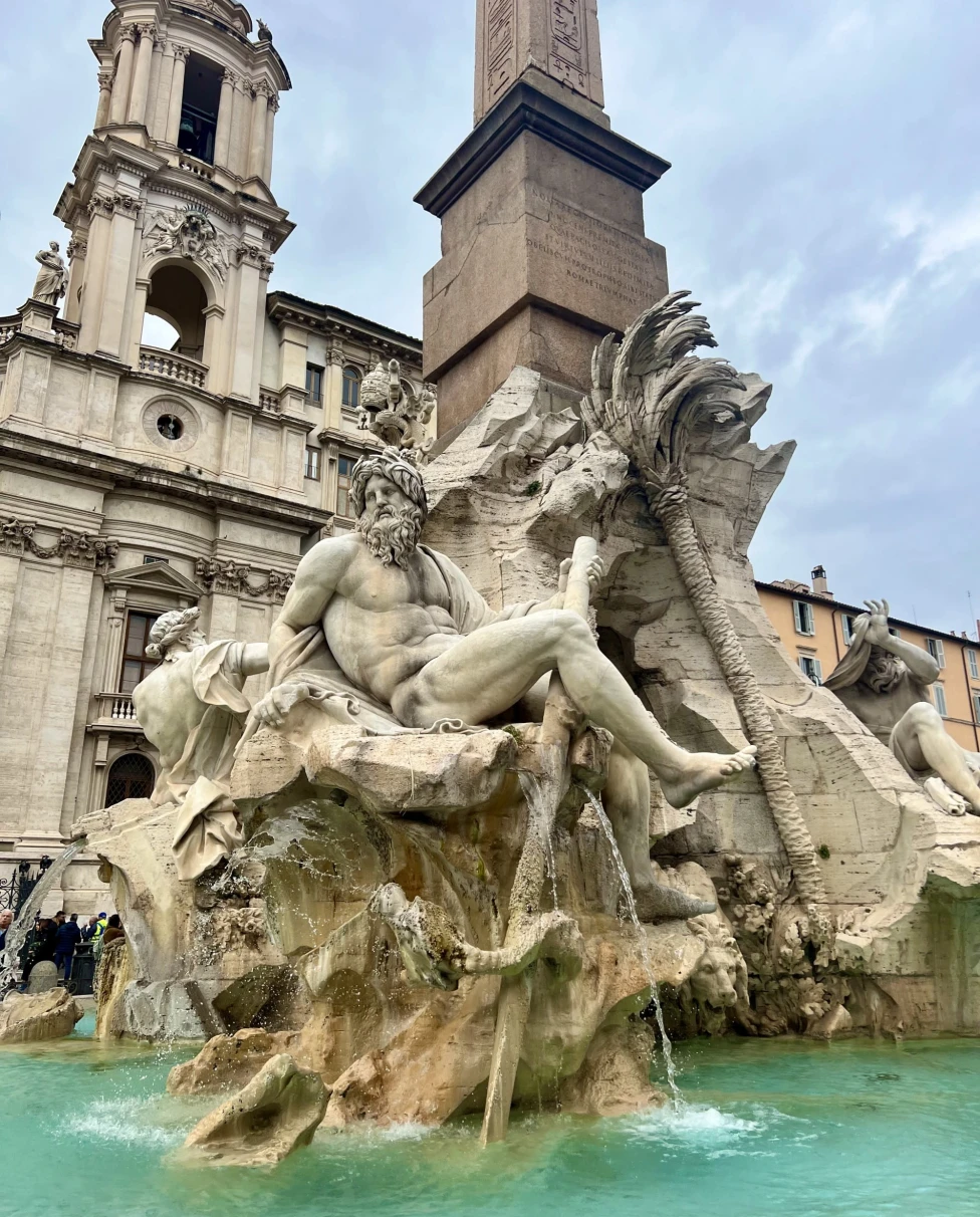 The Fontana dei Quattro Fiumi, a renowned baroque fountain in Rome’s Piazza Navona, adorned with elaborate sculptures and an obelisk.