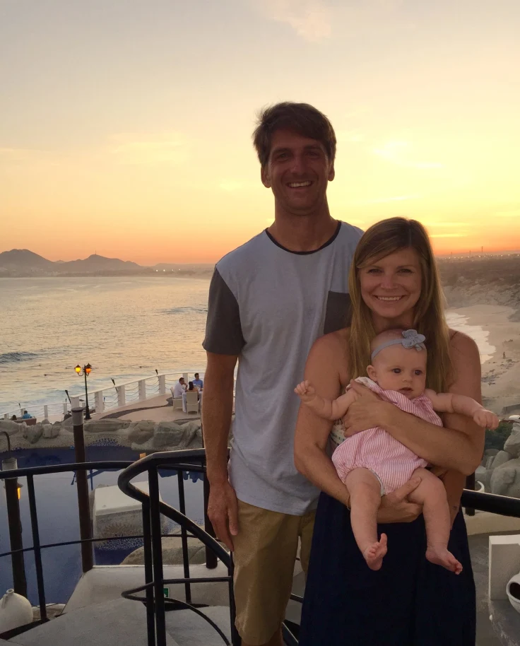 Travel advisor Jena Krinock with partner and baby at Sunset Monalisa restaurant overlooking the ocean at sunset