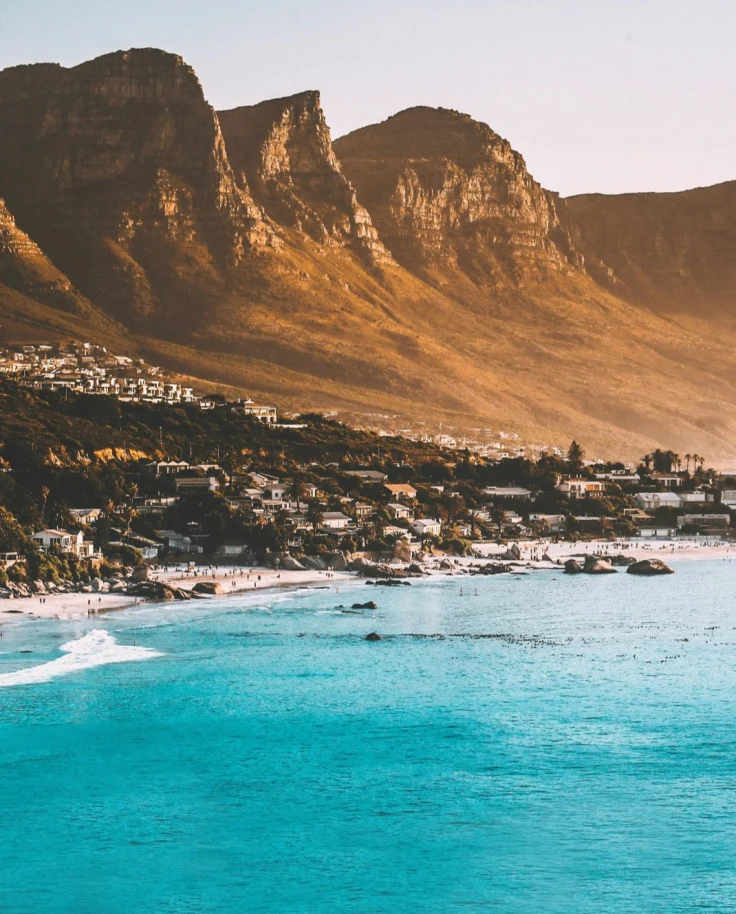 Blue bay with a city and mountains in the background in South Africa.