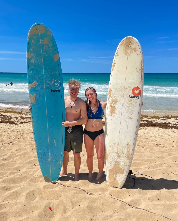 Couple posing with surfing boards