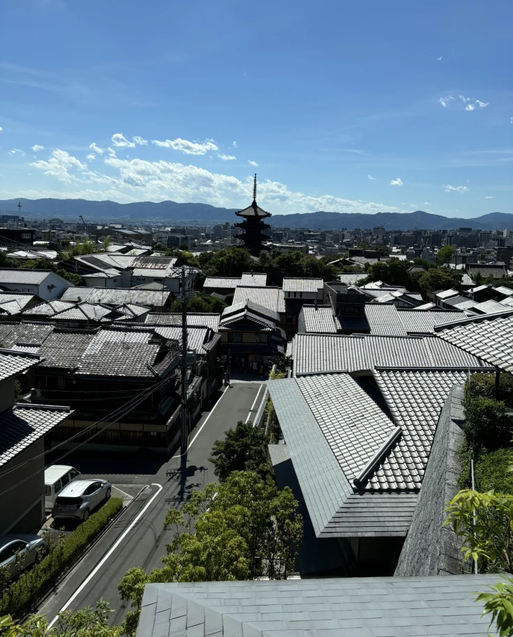 A city view with mountains in the distance during the daytime