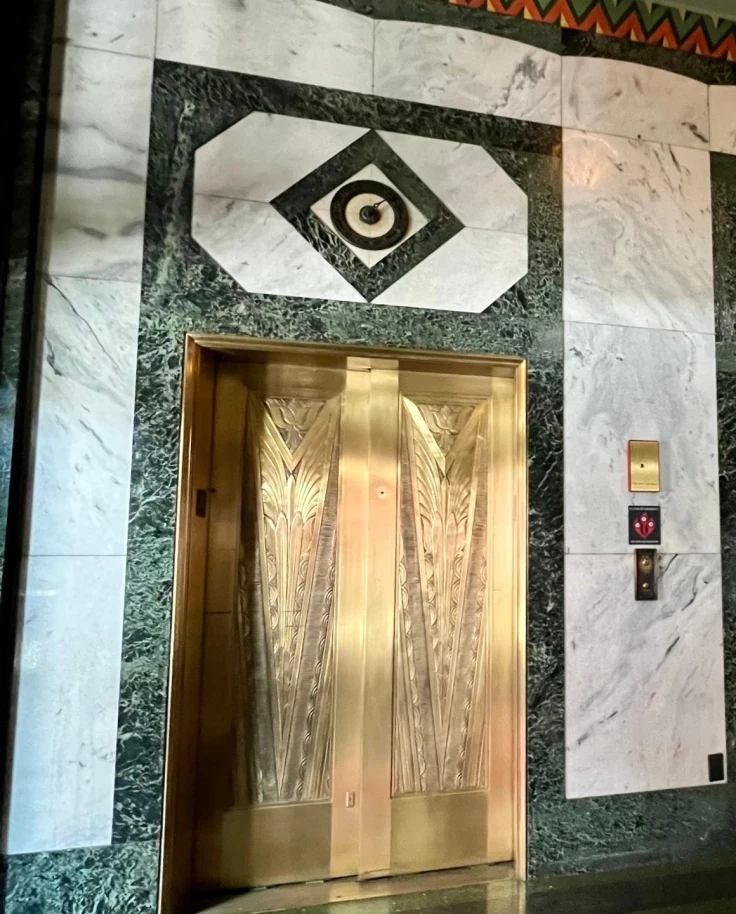 Art deco elevators in the lobby of a hotel.