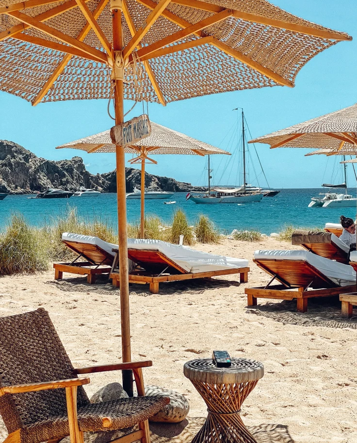 Beach loungers under an umbrella in Ibiza.