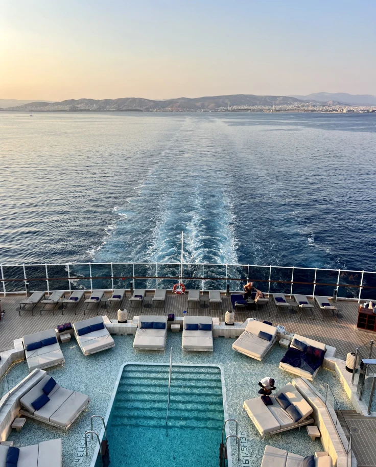 The back of a cruise ship sailing through the water during the daytime