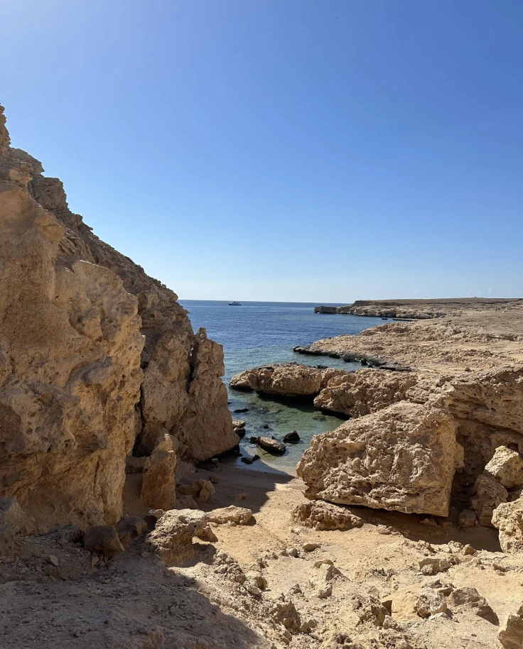 Desert-colored rock outcroppings by the ocean