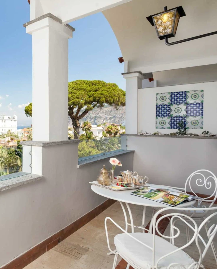 View of trees and the sea from a terrace during daytime
