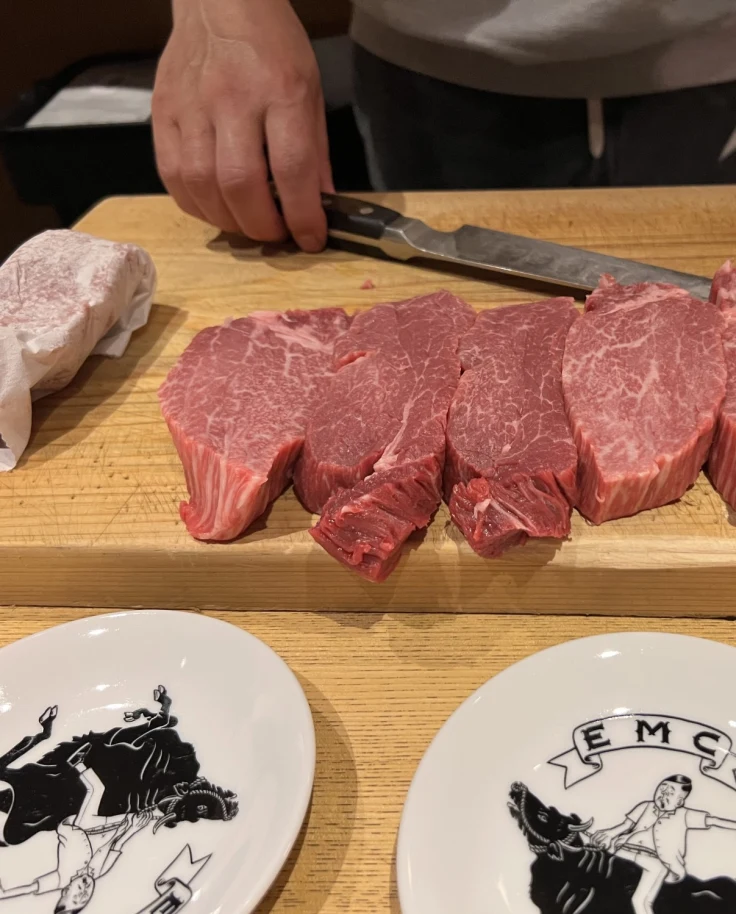 Raw beef slices on a wooden cutting board