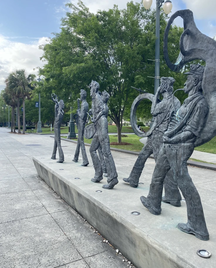A line of sculptures playing musical instruments at Louis Armstrong Park near Hotel Mazarin New Orleans.